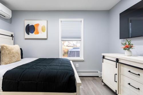 a bedroom with a bed and a window at Comfort Meets Style 3BR Plus Parking in New Rochelle