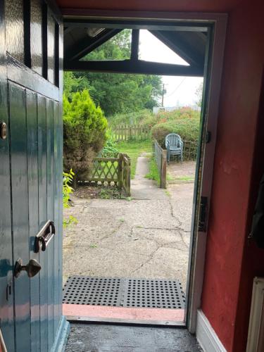 an open door to a yard with a bench at Low Houses Hadrians Wall in Stagshaw Bank