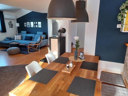 a living room with a table and a blue couch at Ferienwohnung am Sendberg in Frielendorf