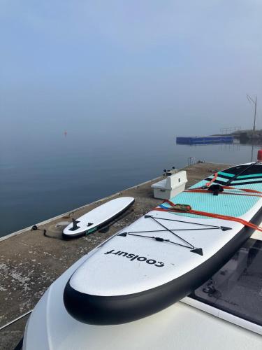 a group of surfboards sitting on top of a dock at Waterfront archipelago house Stockholm in Värmdö