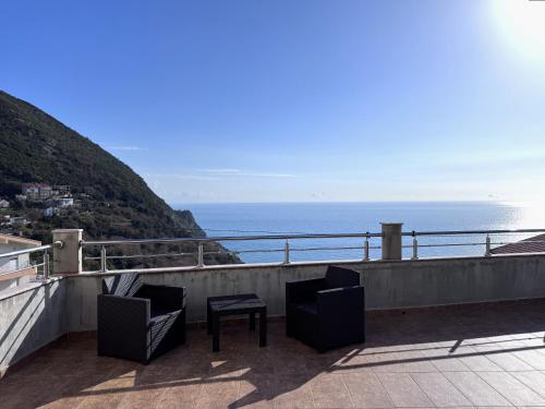 a balcony with two chairs and a table and the ocean at Villa Happy Family!!! in Prijevor