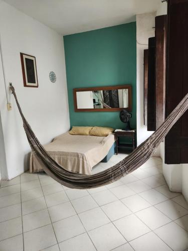 a bedroom with a hammock in a room at Katai in Salvador