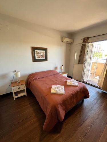 a bedroom with a bed with two towels on it at Casa Dos Avenidas 4 Dormitorios in Montevideo
