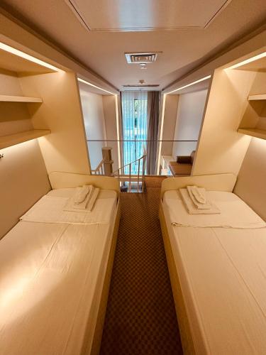a small room with two beds in it at Ortakoy Aparts in Istanbul