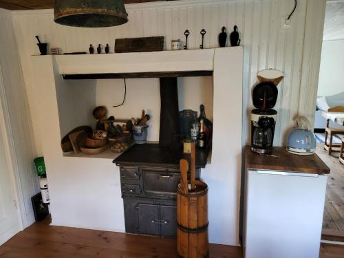 a kitchen with an old wood stove in a room at Bullerbyn - Mellangården - Astrid Lindgren family house in Mariannelund