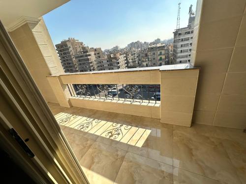 a balcony with a view of a city at King Palace Rooms in Cairo
