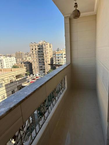 a balcony with a view of a city at King Palace Rooms in Cairo