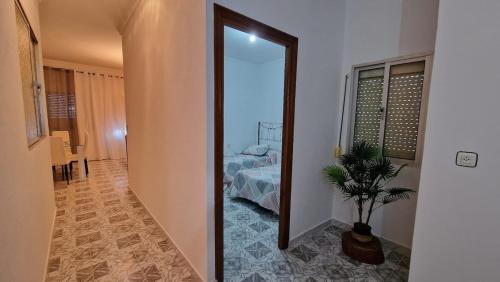 a room with a mirror and a bedroom with a bed at 'La Casa de la Motera' by Turismodecalidad in Algodonales