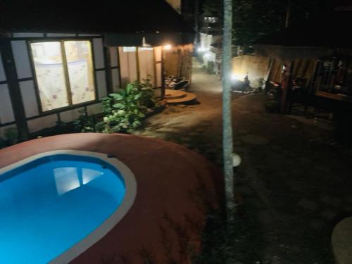a view of a swimming pool at night at khum dara lanta resort in Ko Lanta Yai