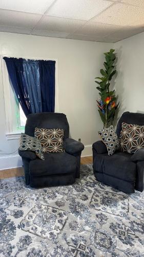 a living room with two chairs and a window at Fall River Complete 2 Bedroom Near Downtown in Fall River