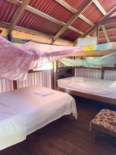 a room with two beds in a roof at Posada Nativa Brisa y Mar in Nuquí