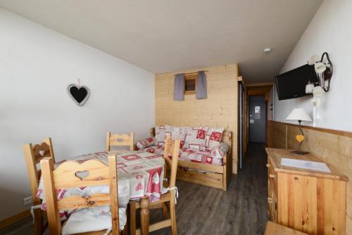 - une chambre avec 2 lits, une table et une télévision dans l'établissement Résidence Etoile - Studio pour 4 Personnes 094, à Aime La Plagne