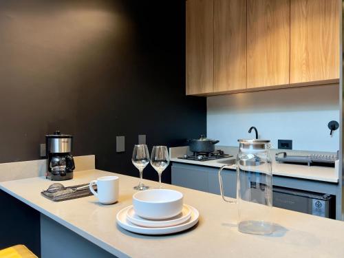 a kitchen with two wine glasses and a counter top at Blok Living in Medellín
