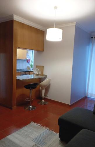 a living room with a counter and a kitchen at Village Sea House - Porto Moniz in Porto Moniz