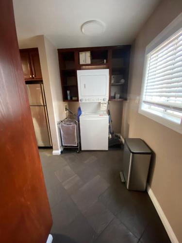 a kitchen with a white refrigerator and a window at Faith House in Los Angeles