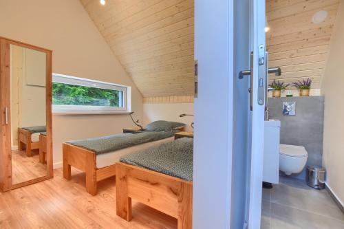 a room with two beds and a mirror at Osada Pod Maliną in Brenna