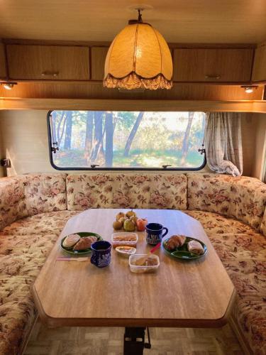 a table with two plates of food on it in a caravan at Hacienda Caravan in Szentes
