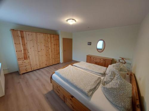 a bedroom with two beds and a mirror at Ferienhaus Auenland in Brunsbüttel