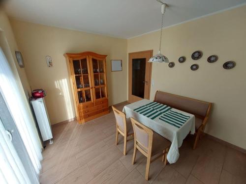 a dining room with a table and chairs in a room at Ferienhaus Auenland in Brunsbüttel