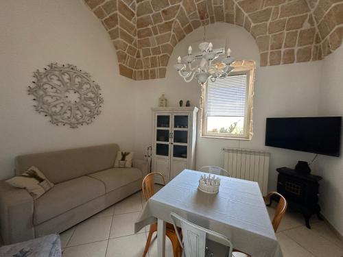a living room with a couch and a table at La terrazza di Lillo in Carovigno