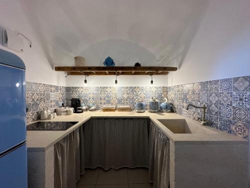 a kitchen with a sink and a counter top at La terrazza di Lillo in Carovigno