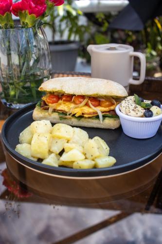 a sandwich and chips on a plate with a cup of coffee at Casa Ramona in Flores
