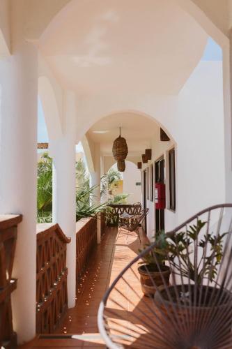 a porch of a house with tables and chairs at Olas de Cerritos in El Pescadero