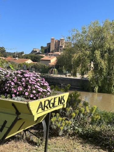 a sign for a garden with flowers and a river at Village villa, private pool, canal du midi in Argens Minervois