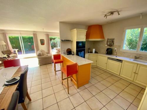 a kitchen with a table and chairs in a room at Village villa, private pool, canal du midi in Argens Minervois