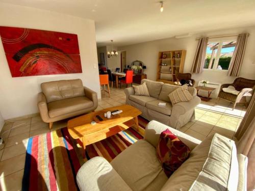 a living room with a couch and a table at Village villa, private pool, canal du midi in Argens Minervois