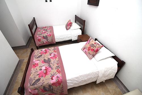 a room with two beds and a couch at Amazilia Hotel in Pereira