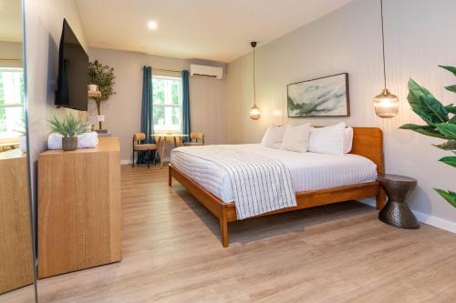 a bedroom with a bed and a dining room at The Dogwood in Maggie Valley