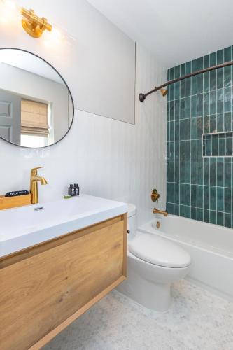 a bathroom with a sink and a toilet and a mirror at The Dogwood in Maggie Valley