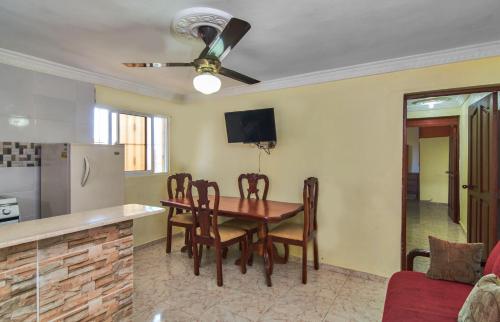 a kitchen and dining room with a table and chairs at BNB Family Vacation Rentals, Corales del Sur, Santo Domingo Este in La Viva