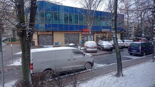 a van parked in a parking lot in front of a building at PRADA Apartament Konin in Konin