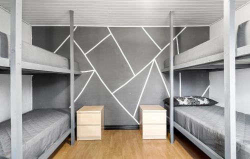 a bedroom with two bunk beds and a geometric wall at Awesome Home In Øster Assels With Wifi in Øster Assels