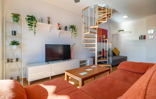 a living room with a couch and a tv at Cozy Apartment In Torrox Costa in Torrox Costa
