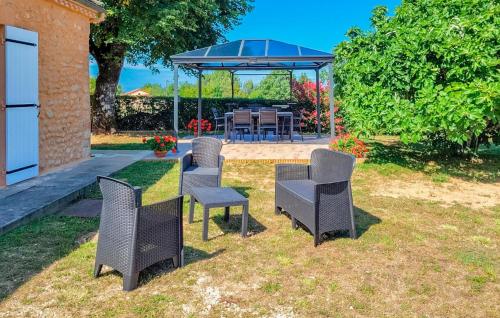 a group of chairs and a table in a yard at 3 Bedroom Lovely Home In La Douze in La Douze