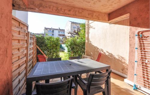 a table and chairs in a room with a window at Nice Apartment In Fréjus With Wifi in Fréjus