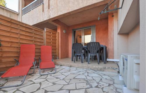 a patio with chairs and a table and a television at Lovely Apartment In Fréjus With Wifi in Fréjus