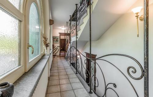 a hallway with a staircase with wrought iron railings at 5 Bedroom Nice Home In Bollengo To in Bollengo
