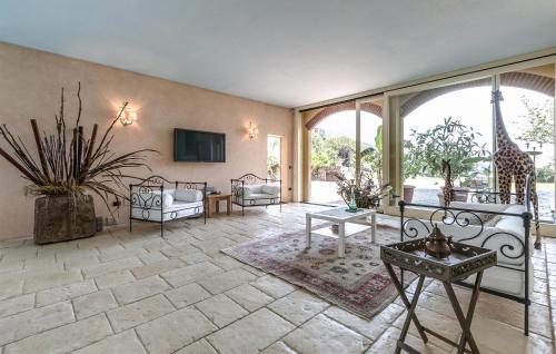 a large living room with a giraffe on the wall at 5 Bedroom Nice Home In Bollengo To in Bollengo