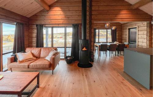 a living room with a couch and a fireplace at Amazing Home In Øyer With Wifi in Øyer
