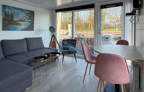 a living room with a couch and a table and chairs at Johannesburg in Naarden