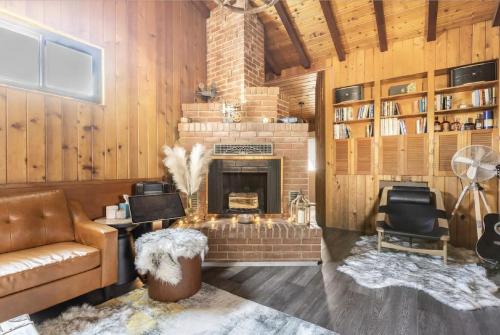 a living room with a couch and a fireplace at Party House Heaven in North Hollywood