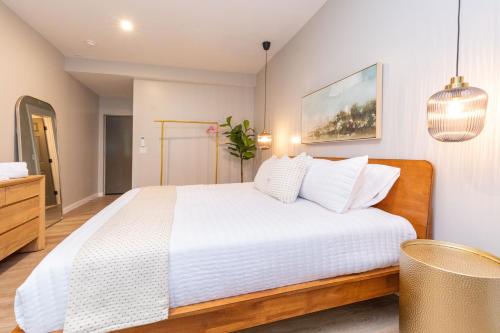 a bedroom with a white bed and a potted plant at The Dogwood in Maggie Valley