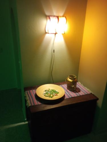 a table with a plate with a light on the wall at Irini in Thérissos