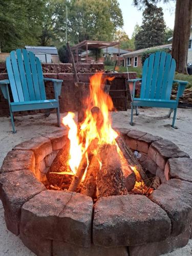 two blue chairs sitting next to a fire pit at Quiet and Smoke FREE private suite in Charlotte