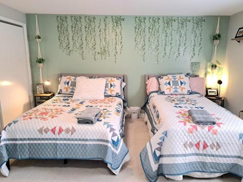 two beds sitting next to each other in a bedroom at Quiet and Smoke FREE private suite in Charlotte