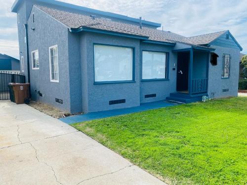 a blue house with a lawn in front of it at Faith House in Los Angeles